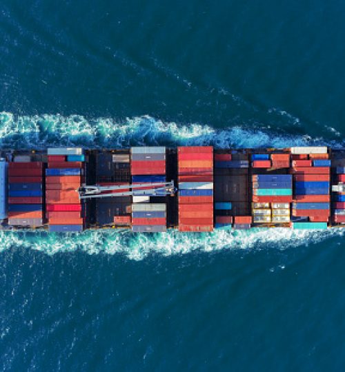 Aerial view Top speed with beautiful wave of container ship full load container with crane loading container for logistics import  export or transportation concept background.